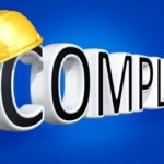 The word compliance with a hard hat